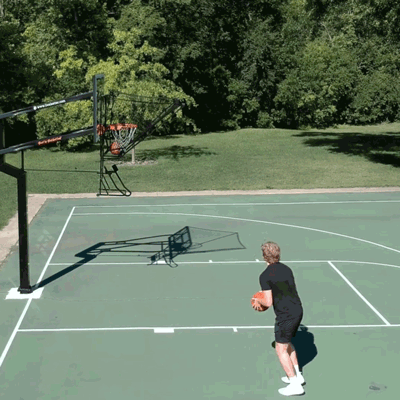 Players shooting on Dr. Dish IC3 Basketball Shot Trainer at park